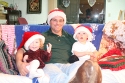 Melanie and Hannah snuggle with Uncle Ken\n(Christmas Eve)